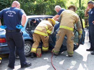 Firefighters rescuing someone from a personal injury car accident.