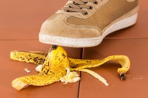 Shoe stepping on a banana peel. Possible slip & fall workers' compensation claim.